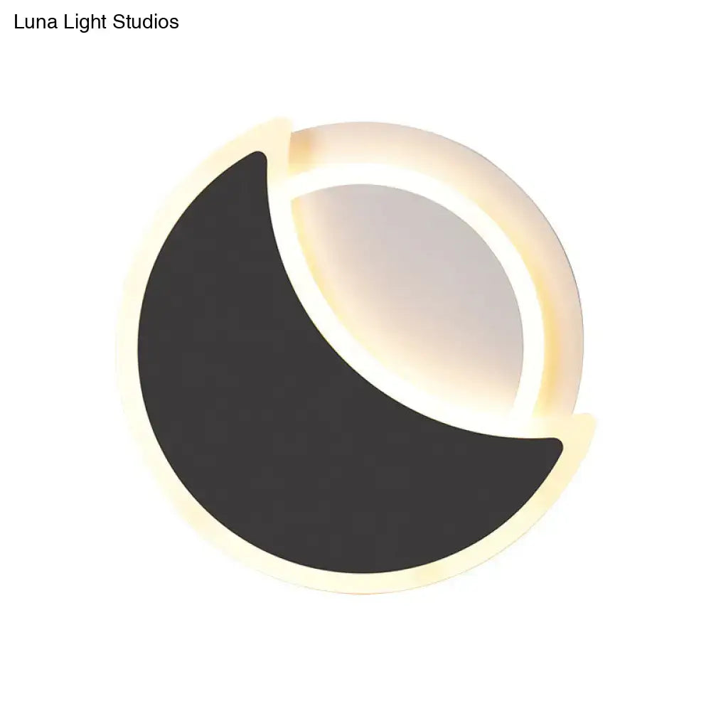 Modern black white acrylic wall sconce shaped like a crescent moon with illuminated edge casting warm glow