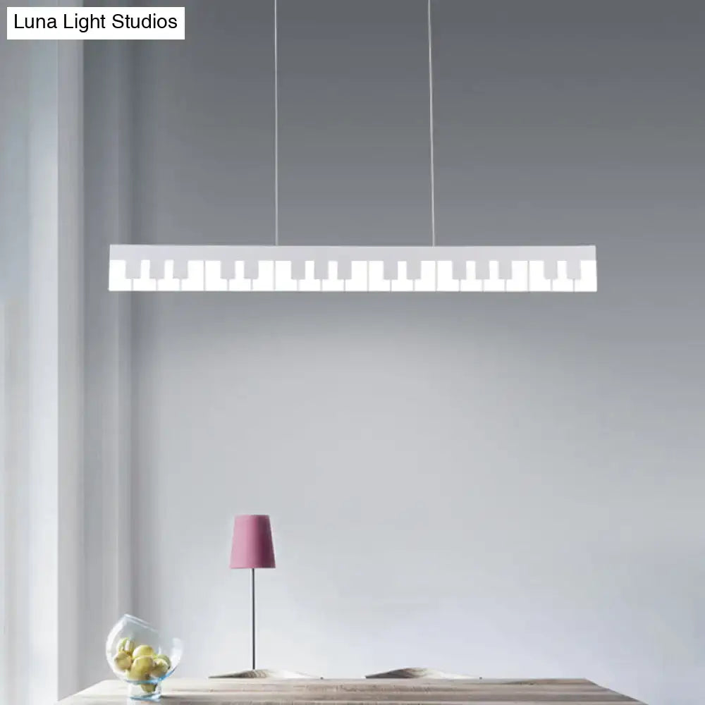 A sleek white acrylic piano key chandelier lamp fixture with minimalist design hangs from thin cords for modern decor