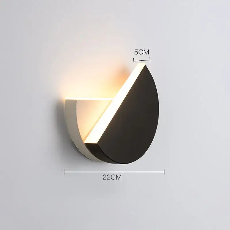 Modern black and white adjustable led wall lamp with sleek angular design emitting warm light for bedroom decorbites decor