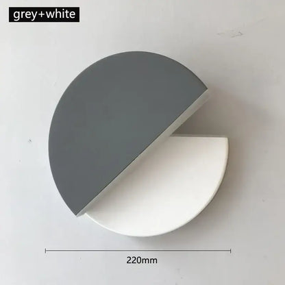 A sleek modern black and white decorbites adjustable led wall lamp with a two-tone grey and white finish for bedroom decor