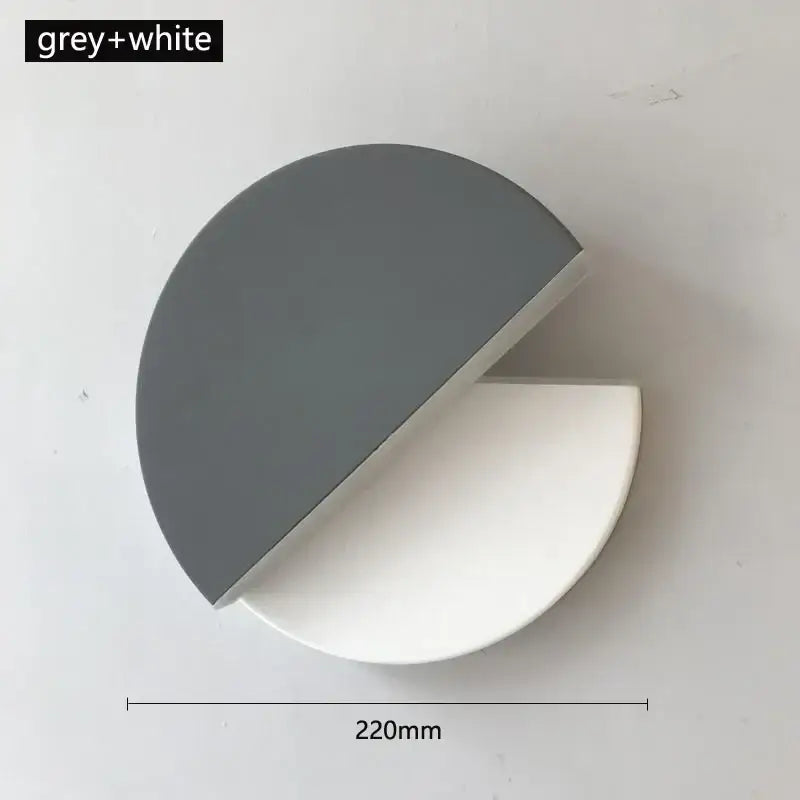 A sleek modern black and white decorbites adjustable led wall lamp with a two-tone grey and white finish for bedroom decor
