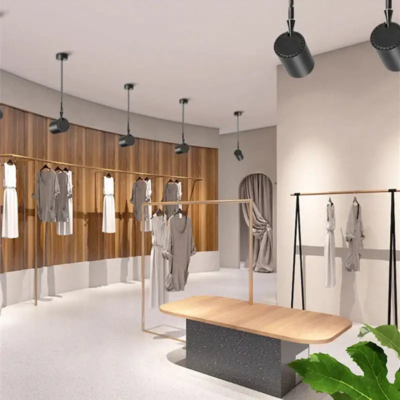 Modern black and white adjustable led wall lamp by decorbites displayed in a minimalist clothing store setting with wooden racks