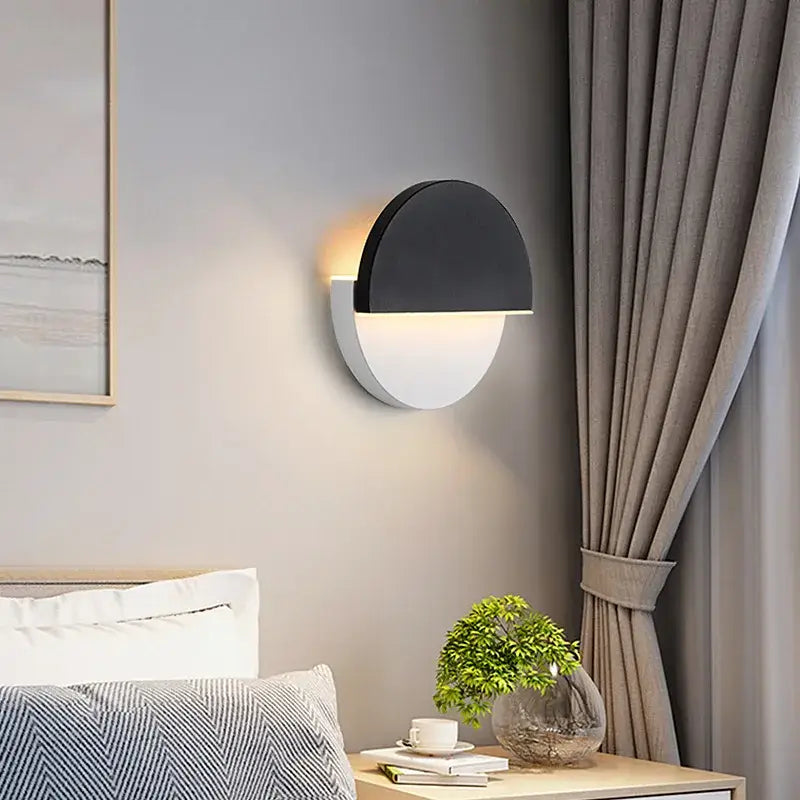 Modern black and white half-moon decorbites adjustable wall lamp with sleek minimalist design for bedroom reading light