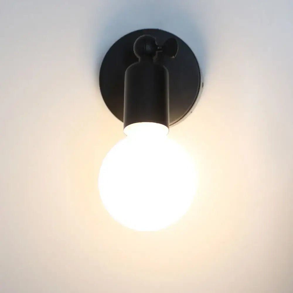 Modern black industrial-style wall lamp holder with glowing bulb for adjustable bedroom wall lamp sconce