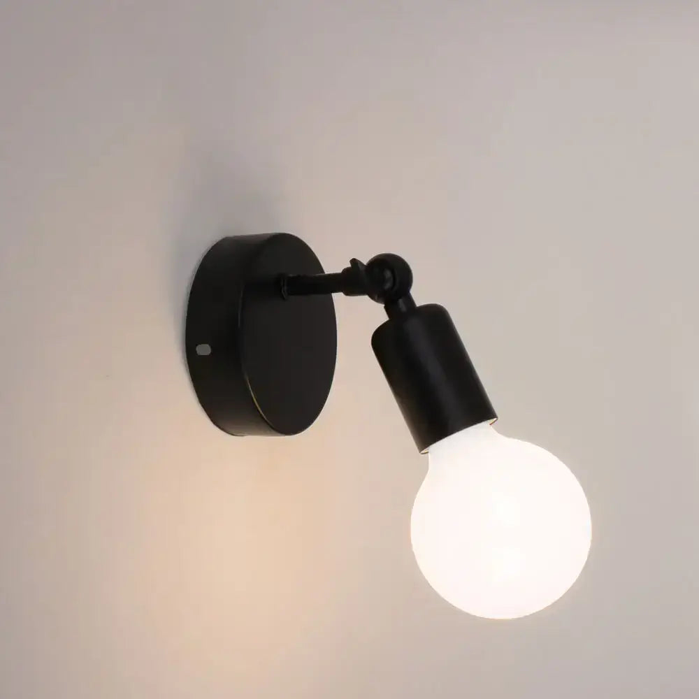 Modern black wall lamp holder with matte finish and adjustable arm holding frosted glass bulb for bedroom sconce lighting
