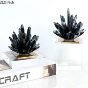 Modern black agate flower crystal art featuring black and white striped agate plant sculptures on gold-toned bases