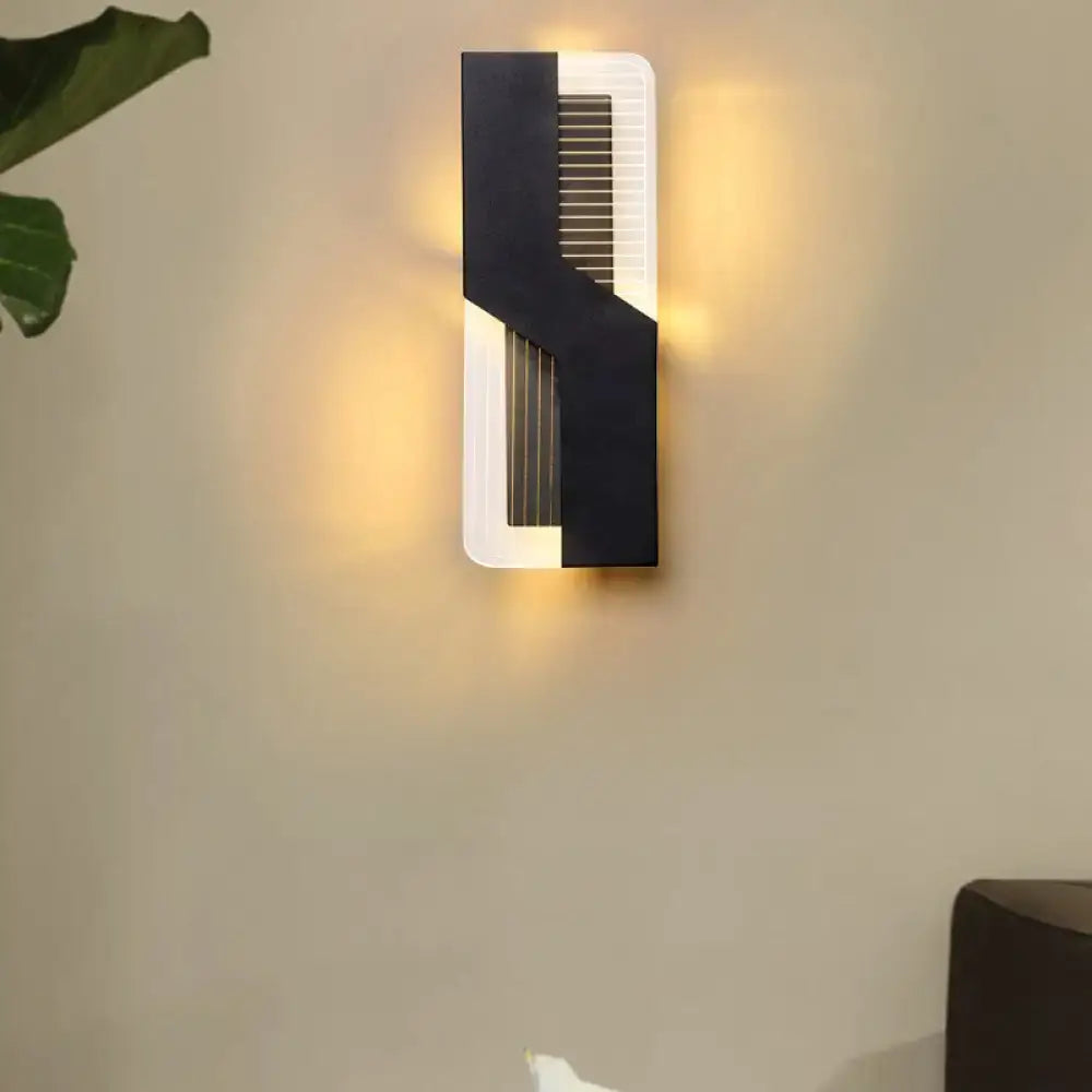 Modern black and white angular led wall mount light featuring a sleek geometric design for bedroom sconce use