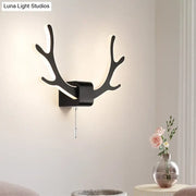 Modern black and white antler wall sconce with warm white led lighting and pull chain switch for bedroom use