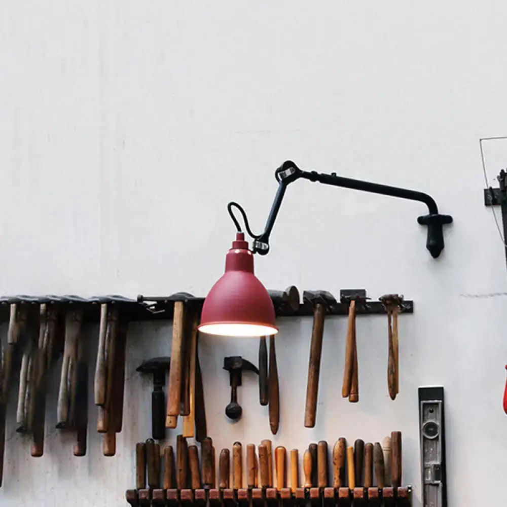 Red industrial-style wall lamp with black articulated arm designed for direct wired electric power use in modern bedrooms