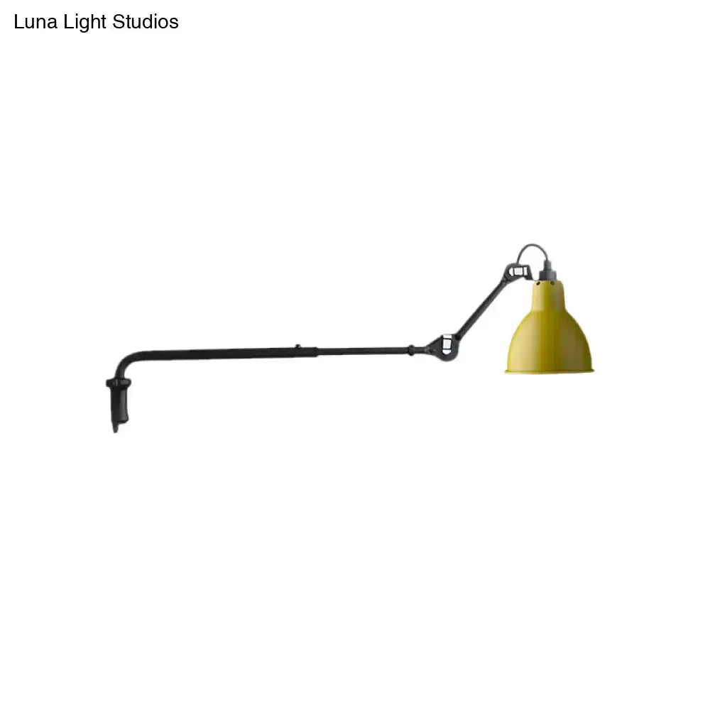 Yellow conical lampshade on modern black and white articulated bedroom wall lamp with direct wired electric power source