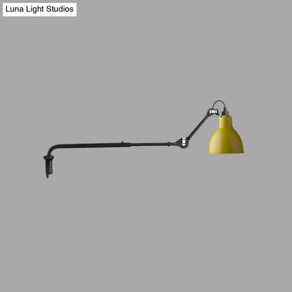Yellow conical shade on modern black and white articulated bedroom wall lamp with direct wired electric power source
