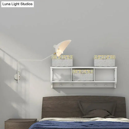 White wall-mounted shelf with three wicker baskets and floral lining paired with modern black and white wall sconce light fixture for living room