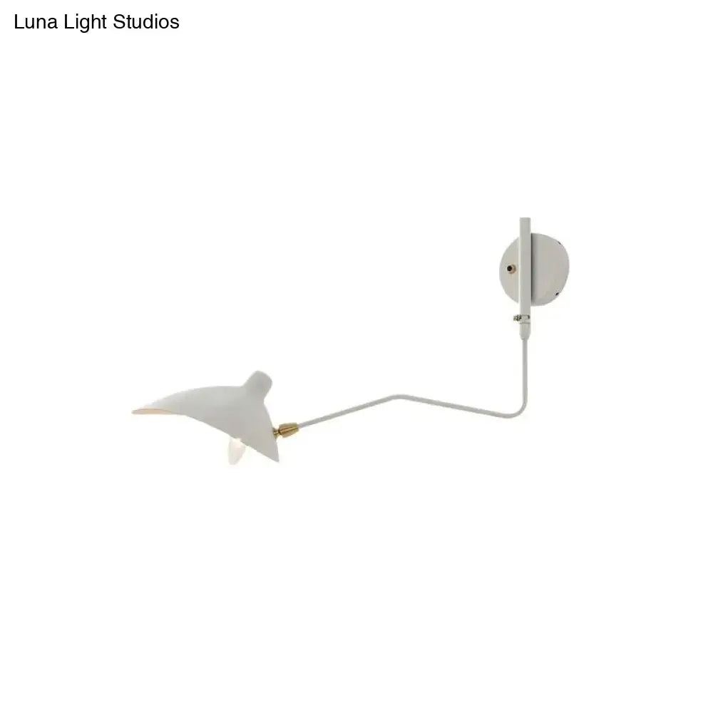 White wall sconce with a sleek articulated arm and sculpted bird shade modern light fixture for living room