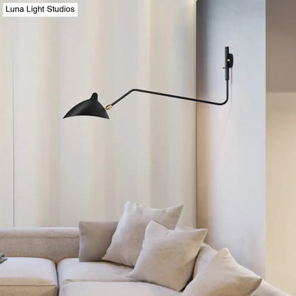 Modern black wall sconce with sleek articulated arm and conical shade for stylish living room light fixture