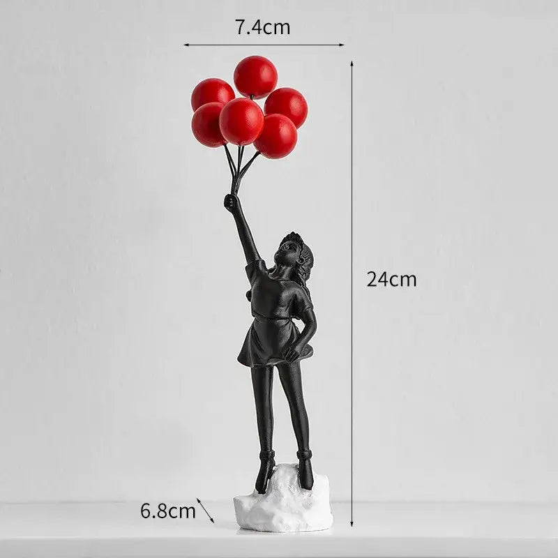 Modern black and white balloon girl graffiti statue featuring a black resin girl holding red balloons on white base