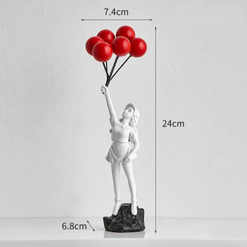White resin balloon girl graffiti statue holding red balloons on black rocky base modern living room decor
