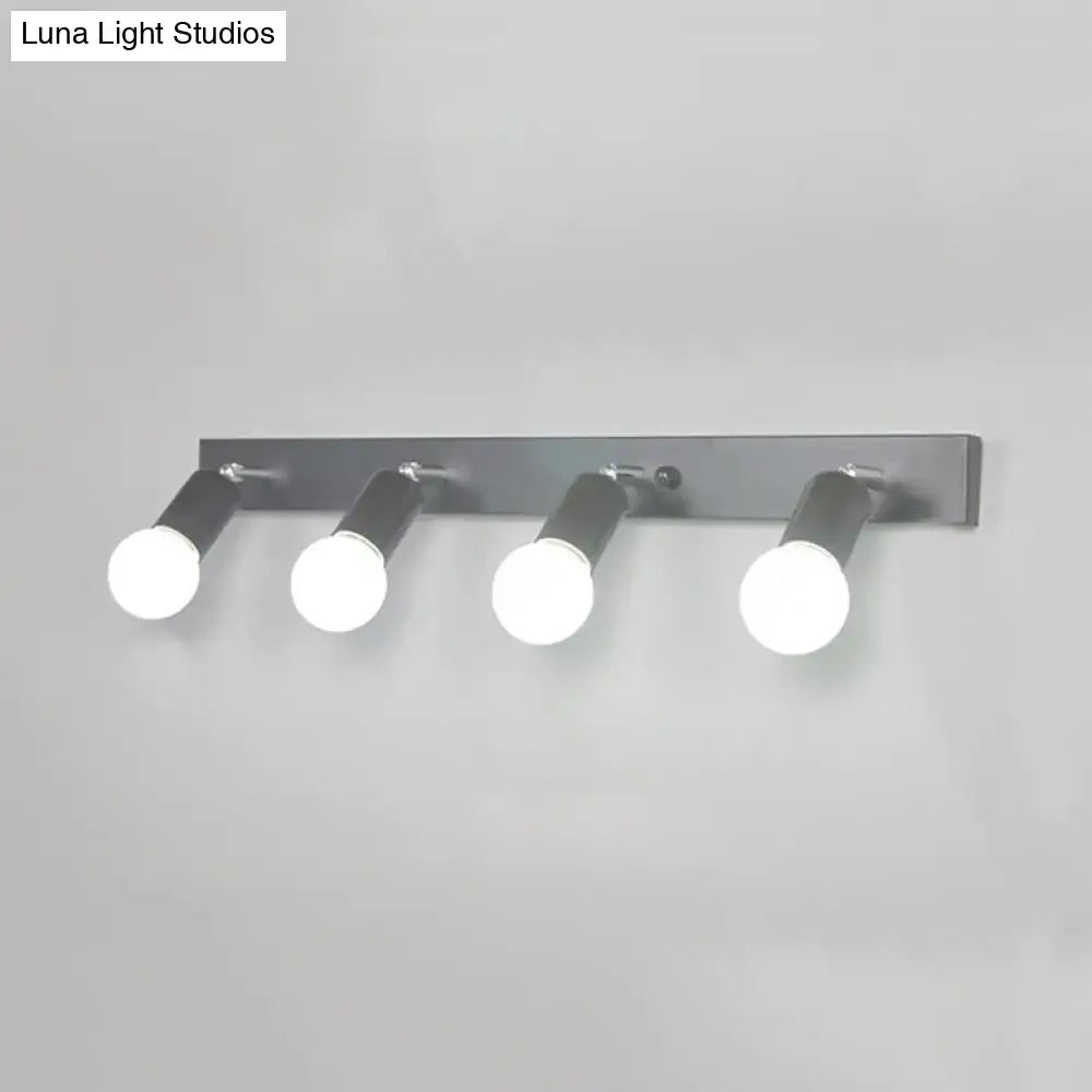 Modern black and white bedroom vanity light with chrome finish and four adjustable exposed bulb spotlights wall-mounted