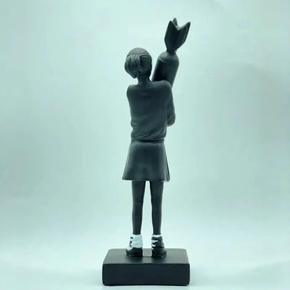 Modern black and white bomb hugger girl resin statue featuring a black resin hugger girl holding oversized candy cane decorbites bomb hugger