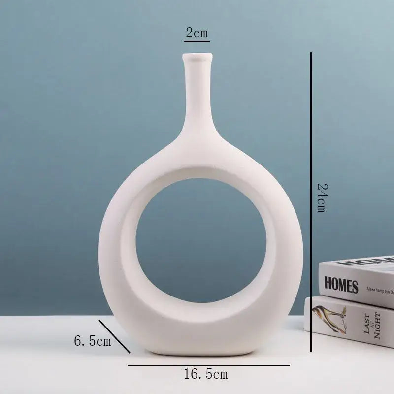 White ceramic vase with sleek modern design and circular cutout from decorbites ceramic vase set for living room decor