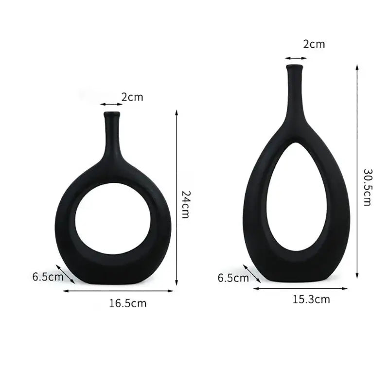 Two sleek black decorbites ceramic vases with oval bodies and circular cutouts for modern living room decor