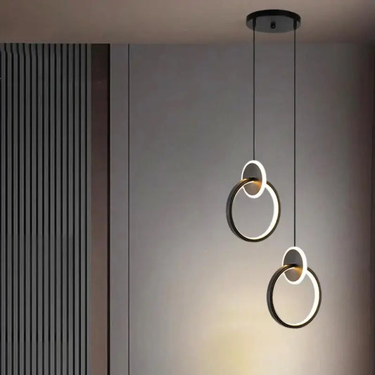 Modern black and white circular bedside pendant light with adjustable hanging length and sleek minimalist design
