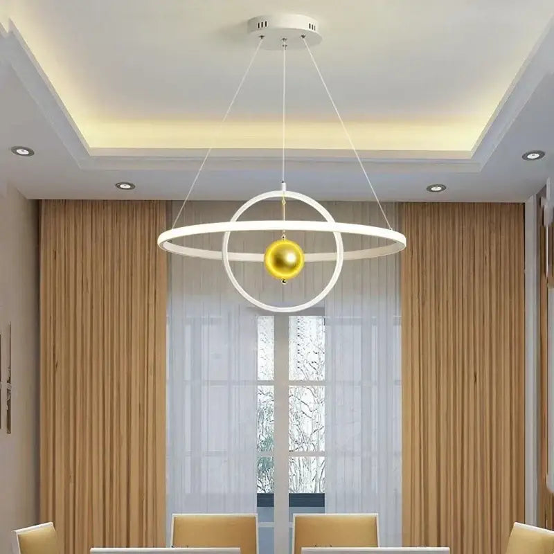Modern black and white circular iron ball pendant featuring a white circular light with a central golden sphere for living room decorbites circular iron lighting
