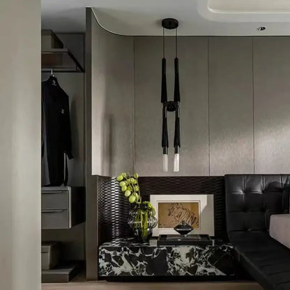 Modern black and white cloth pendant light above black and white marble console table with textured leather accent