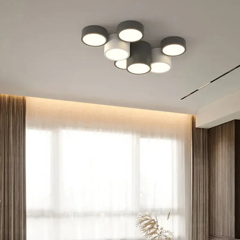 Modern black and white decorbites geometric chandelier with six matte gray cylindrical shades and warm white bulbs