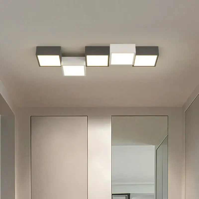 Modern black and white decorbites geometric chandelier with sleek matte finish and four illuminated square panels