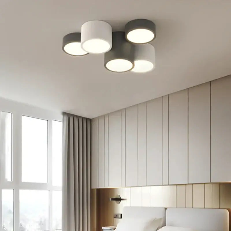 Modern black and white decorbites geometric chandelier with four white and matte gray cylindrical shades for bedroom lighting