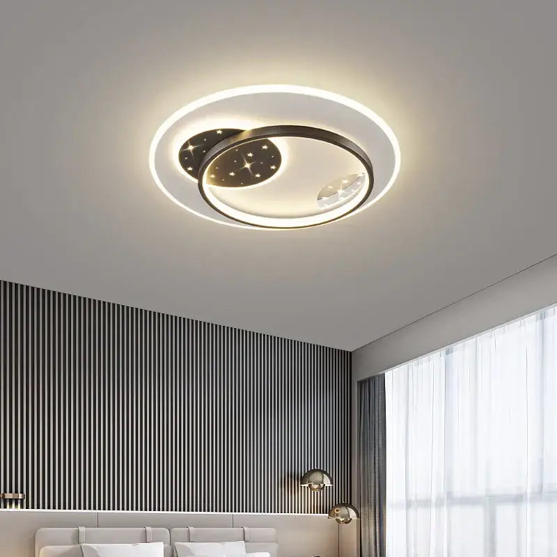 Modern black and white decorbites living lamp chandelier featuring circular design with glowing ring and celestial motifs