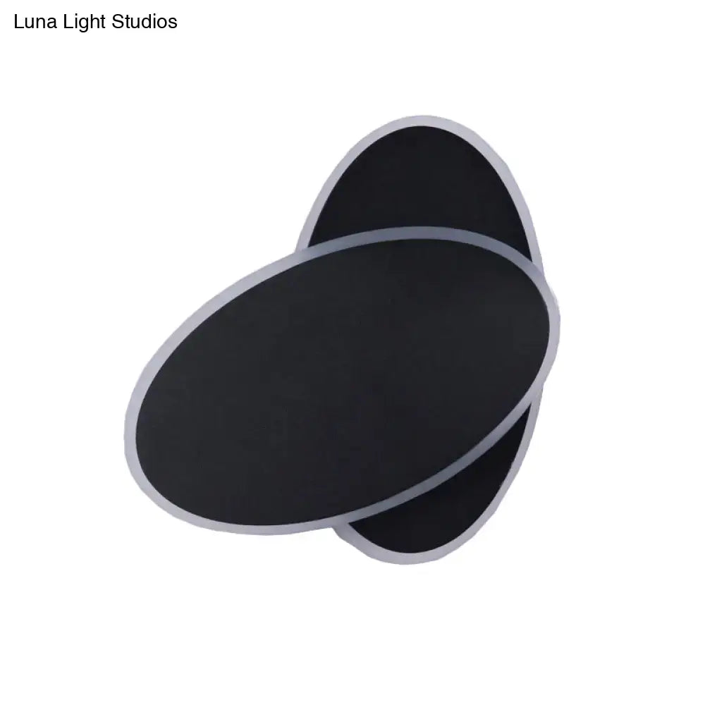 Modern black double oval wall sconce lamp with silver metallic trim for bedside bedroom lighting