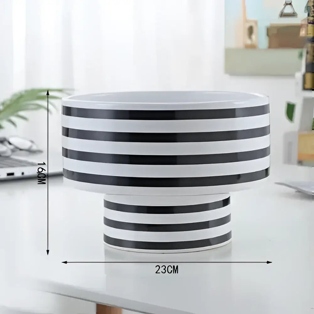 A sleek black and white elegant striped ceramic vase perfect for modern living room decor by decorbites