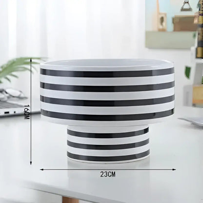 A sleek black and white elegant striped ceramic vase perfect for modern living room decor by decorbites