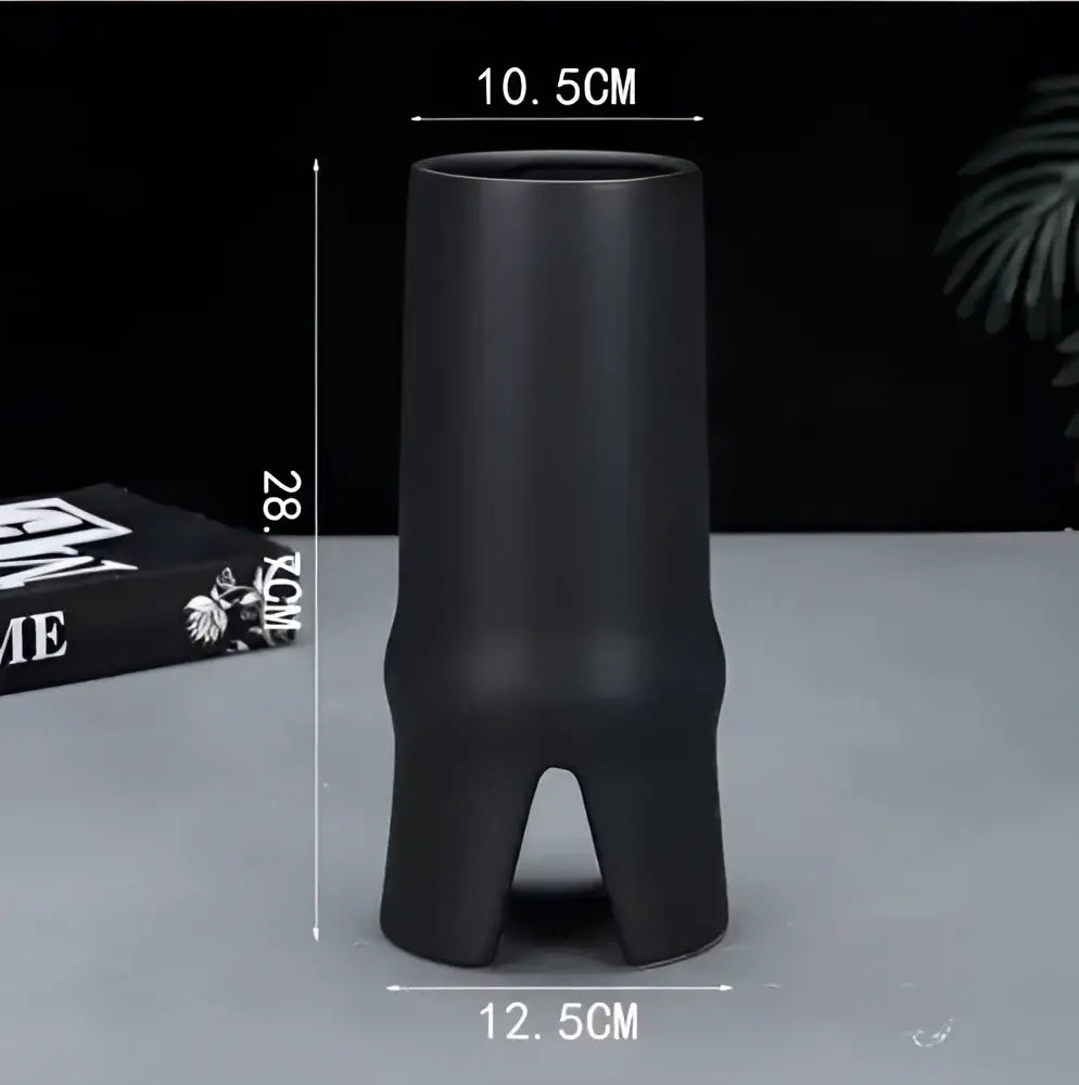 Modern black elegant striped ceramic vase with sleek design and three supportive feet for living room decorbites decor