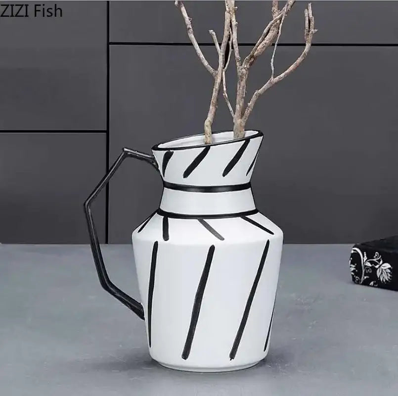 White ceramic elegant striped ceramic pitcher with black geometric stripes and hexagonal handle holding dried branches for decorbites elegant striped decor