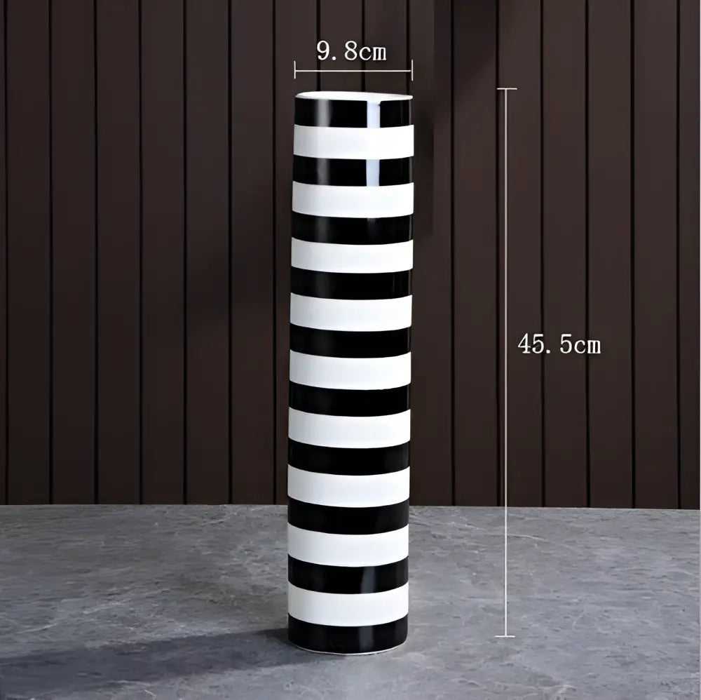 A tall elegant striped ceramic vase with bold black and white stripes for modern living room decorbites decor