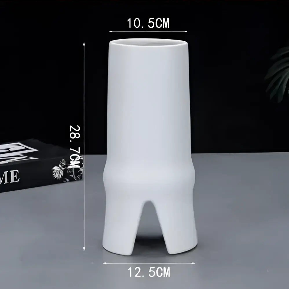 White ceramic vase with elegant striped design and three feet for modern decorbites elegant striped ceramic decor