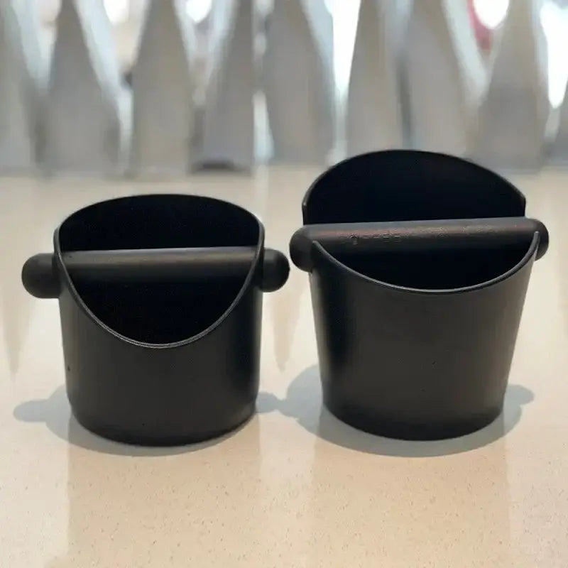 Modern black and white espresso knock box with a black coffee scoop featuring a matte finish and ergonomic handle for decorbites espresso knock