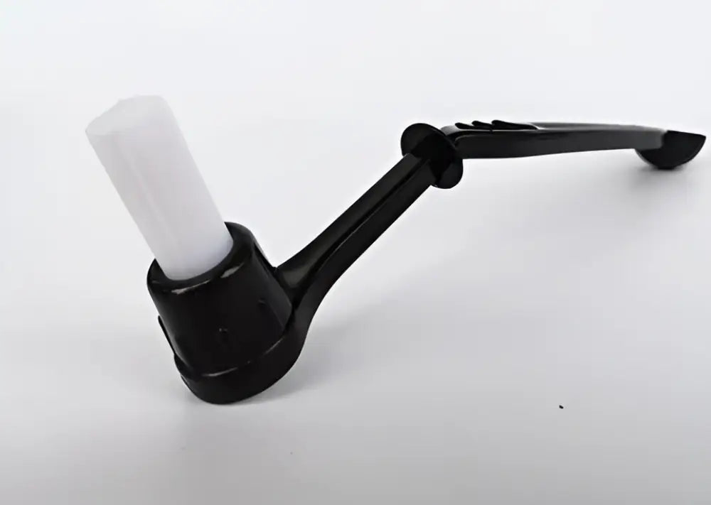 Modern black and white decorbites espresso machine brush with black plastic handle and white cylindrical attachment
