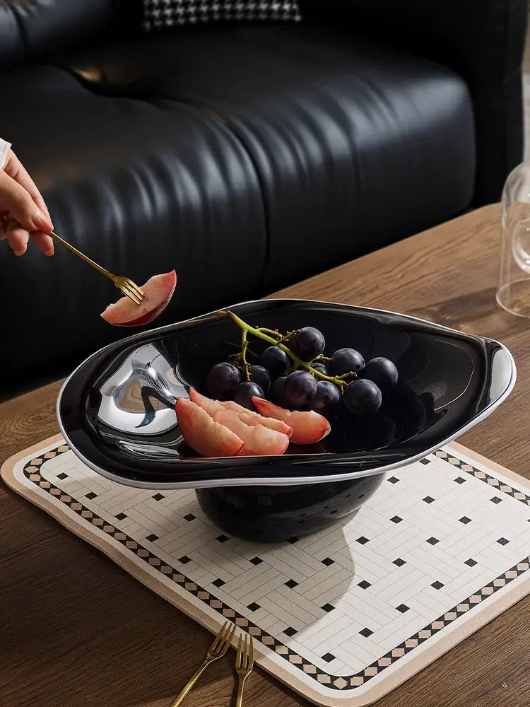 Modern black ceramic fruit bowl with sleek silver rim complementing decorbites geometric acrylic fruit plate design