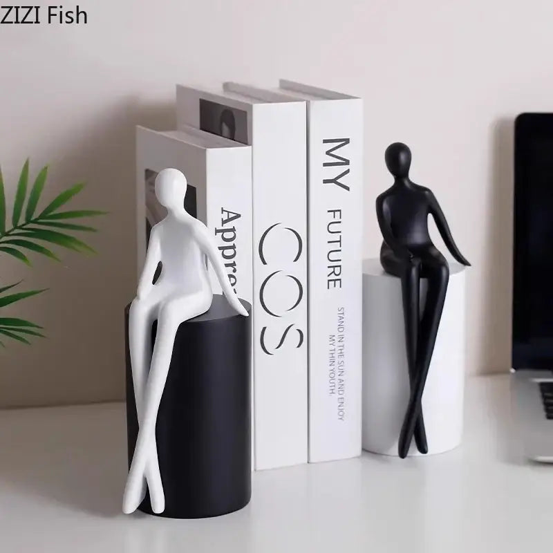 Modern black and white minimalist figurine bookends with sleek abstract human forms on geometric base decorbites geometric base character