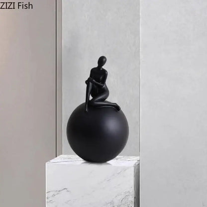 Modern black matte figurine of a seated human form on a geometric base character decorbites geometric base decor