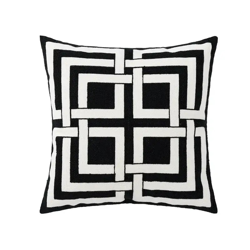 Modern black and white geometric embroidered cushion cover with bold interlocking square pattern for living room