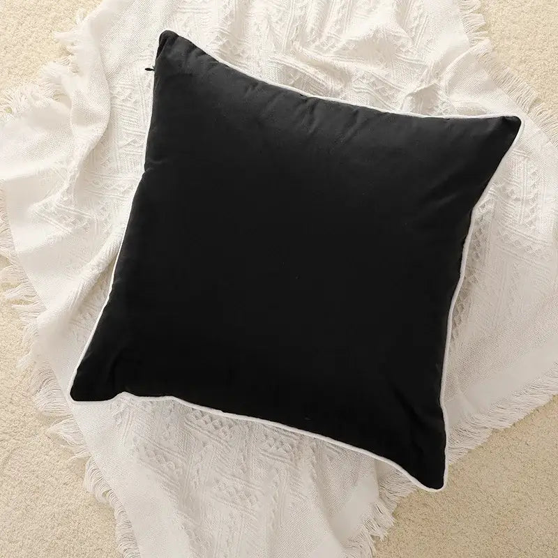 Black velvet square cushion cover with white piping featuring geometric embroidered design for living room decor