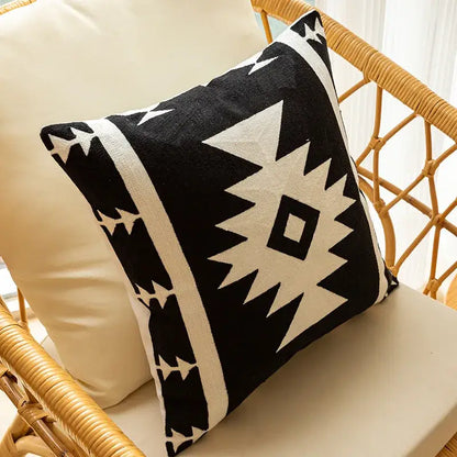Modern black and white geometric embroidered cushion cover with bold tribal-inspired pattern for living room decor