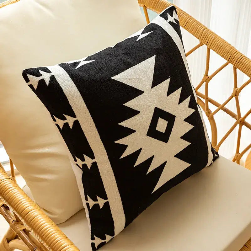 Modern black and white geometric embroidered cushion cover with bold tribal-inspired pattern for living room decor