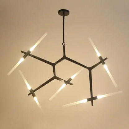 Modern black metal ceiling light with six illuminated frosted glass led rods in a geometric starburst pattern