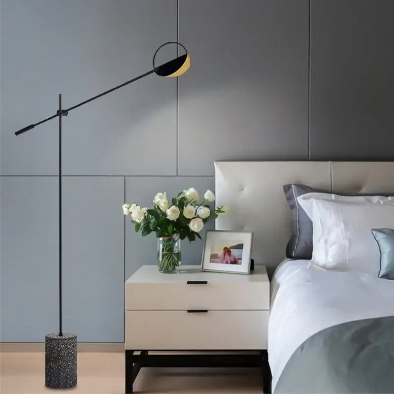 Modern black floor lamp with circular black and gold shade on adjustable arm complements decorbites geometric line pendant lamp
