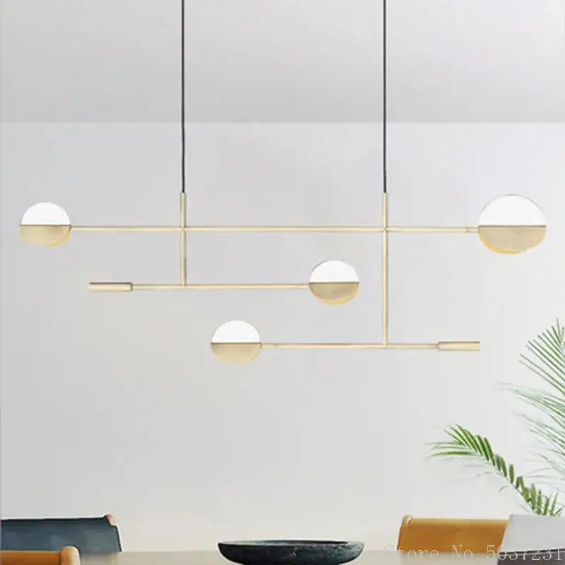 Modern gold-toned pendant light with frosted glass globe shades featuring decorbites geometric iron design